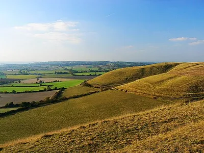 A view from Oliver's Castle, near Heddington The viewpoint is the western edge of the early Iron Age univallate hillfort. At the right is the edge of the Beacon Hill escarpment, which is access land. Although the land at the foot of the hill is farmland it is possible to cross it via a footpath. The line of sight is across the two degrees west meridian which, uniquely in the UK, coincides with an OSGB1936 south-north gridline.