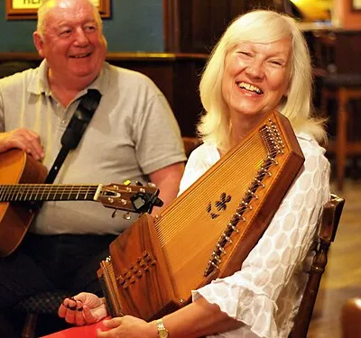 Woman with autoharp bluegrass night at The Village Inn in Nailsworth, Gloucestershire, England on July 25, 2012.