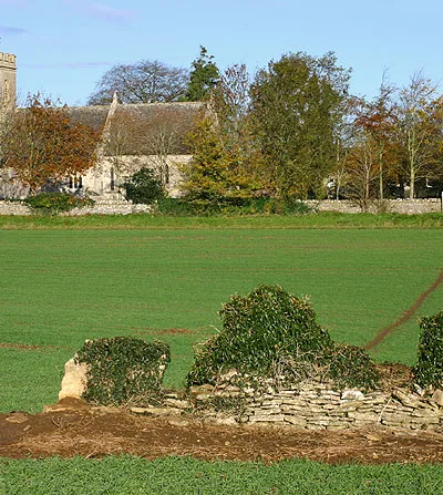 Church of England parish church of Holy Rood, Shilton, Oxfordshire. The footpath from Kenn's Farm crosses the fields towards the church.
