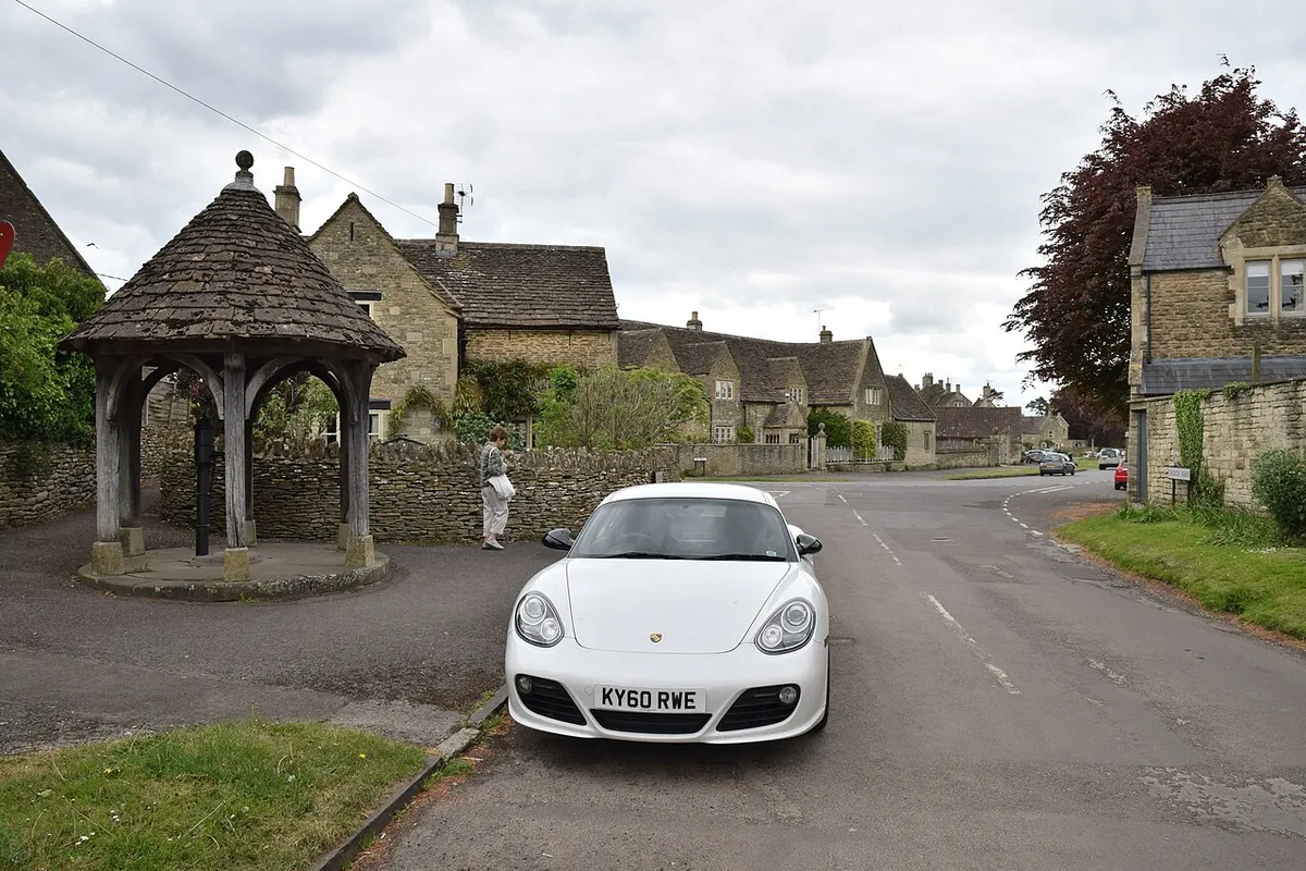 2010 Porsche Cayman S and village pump at Biddestone, Wiltshire, 13 May 2017.