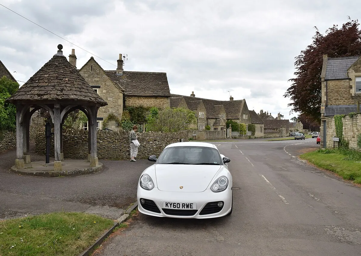 2010 Porsche Cayman S and village pump at Biddestone, Wiltshire, 13 May 2017.